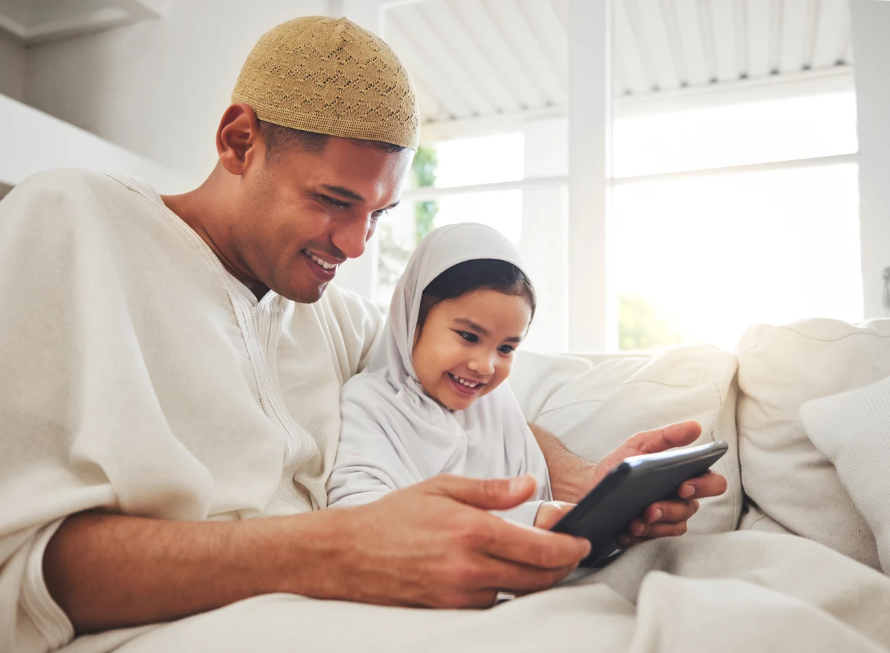 A father and daughter sharing a learning moment with a tablet