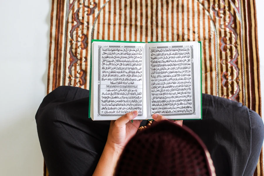 An open Qur’an held carefully during a quiet moment of reading